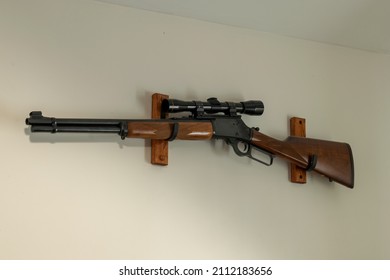 Lever Action Rifle With Scope On Wall