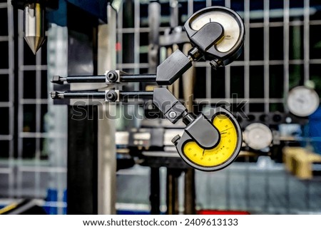 Lever type indicators for measuring runout and accuracy of parts and cutting tools.