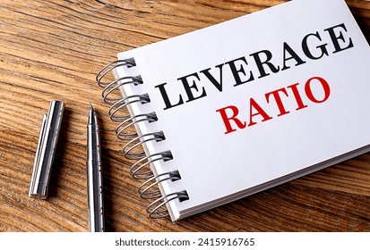 LEVERAGE RATIO text on a notebook with pen on wooden background