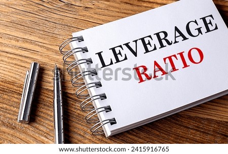 LEVERAGE RATIO text on a notebook with pen on wooden background