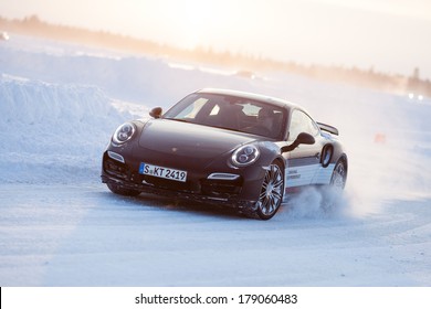 LEVI, FINLAND - FEB 20: Unknown Driver Powerslides A PORSCHE 911 TURBO Car During Porsche Driving Experience Snow & Ice Press Event On February 20, 2014 In LEVI, FINLAND