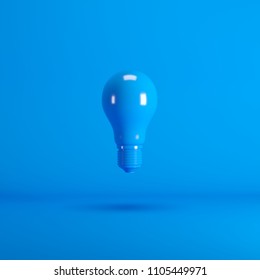 Levitating Blue Lightbulb floating on blue background color. minimal idea concept.