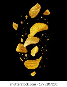 Levitation flying potato chips with onions and peppers on a black background. Advertising concept.