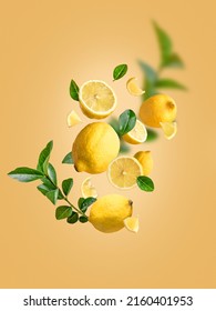 Levitation of fresh lemons and green leaves in the air on an isolated yellow background. Different parts:whole and sliced ​​lemons falling in the air.Creative drink advertising concept.Food levitation - Shutterstock ID 2160401953