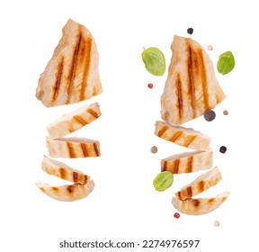 Levitation grilled chicken breast isolated on white background. Grilled chicken slices with pepper mix peas and fresh basil leaves. flying food