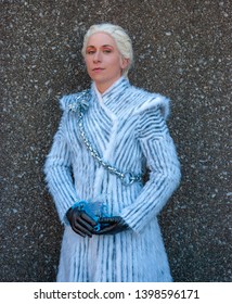 Lexington, Kentucky, US - March, 23 2019 - Lexington Comic And Toy Con - A Cosplayer Is Dressed As Daenerys Targaryen From Game Of Thrones Wearing A Heavy White Coat And Posed Against A Stone Wall