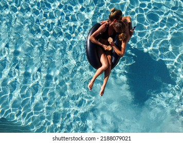 Lgbt Couple Drinking And Hugging Each Other In Swimming Pool, View From Above