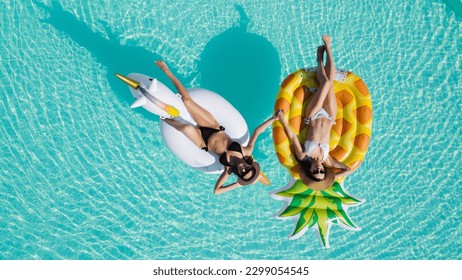 lgbt couple drinking and hugging each other in swimming pool, view from above. - Powered by Shutterstock