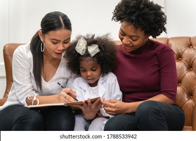 LGBT Diversity Lesbian Couple Moments Happiness With Her African Girl Laughing And Drawing Picture, Family Concept