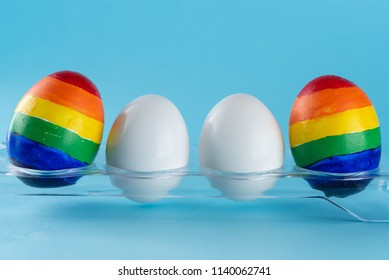 Lgbt Family. Eggs Parents With Lgbt Flag Color And Two White Baby Egg Twins On Blue Background. Creative Idea For Illustration Surrogacy Law, Right Homosexual Couple Adoption And Raising A Child.