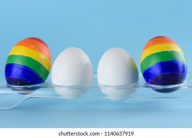 Lgbt Family. Eggs Parents With Lgbt Flag Color And Two White Baby Egg Twins On Blue Background.Creative Idea Illustration Surrogacy Law, Equality In Rights To Have Children,homosexual Lesbian Couple.