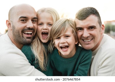 LGBT Family Outdoor - Happy Gay Men Couple And Sons Having Fun Together At City Park - Focus On Center Kid Face