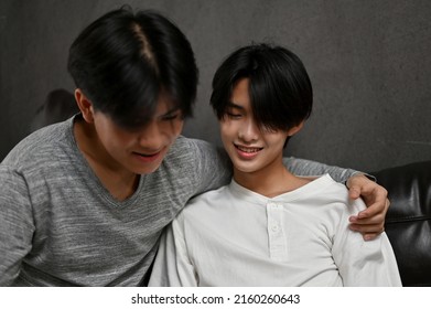 LGBT Gay Men Couples, A Man Put His Arm Around His Boyfriend's Shoulders. Intimate Guy Friends Showing Some LGBT Affection.