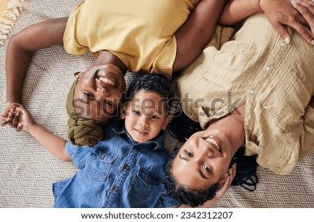 LGBT, happy portrait and relax family, child or people care, smile and lesbian bond together, lying and on floor carpet. Mothers face, top view kid and non binary parents, homosexual mom or gay women