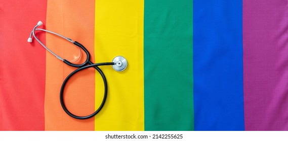 LGBT Health Care. Medical Stethoscope On Rainbow Pride Flag Background, Top View. Transgender And Gay Health Treatment And Rights, Copy Space