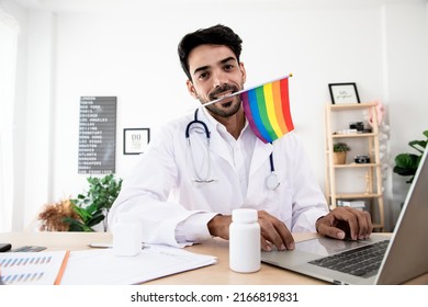 LGBT Health Handsome Doctor With Rainbow Flag. Bisexual, Lesbian And Transgender Care Concept. Work From Home In The Bedroom