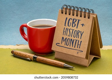 LGBT History Month - Handwriting In A Small Desktop Calendar With A Cup Of Coffee Against Abstract Paper Landscape, Reminder Of Cultural And Heritage Event