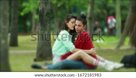 Similar – 2 young women sitting opposite each other