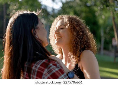 LGBT Lesbian Couple intimate moments. Young couple multiracial female friends. multi-ethnic female couple in love hug each other  - Powered by Shutterstock