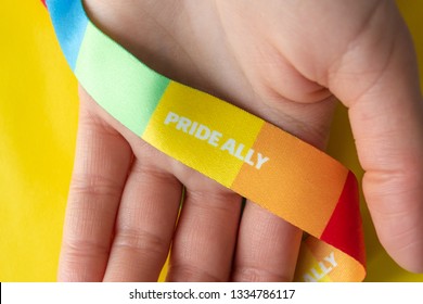 LGBT symbol - hand with rainbow ribbon and pride ally, the concept of support of the LGBT community - Shutterstock ID 1334786117