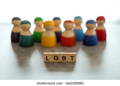 LGBT word on wooden blocks with diverse people in the background - Shutterstock ID 1662289882