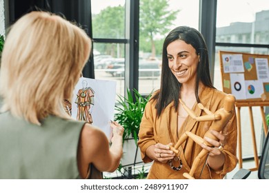 LGBTQ couple, dressed in smart casual attire, discuss a fashion design sketch in a modern office setting. - Powered by Shutterstock