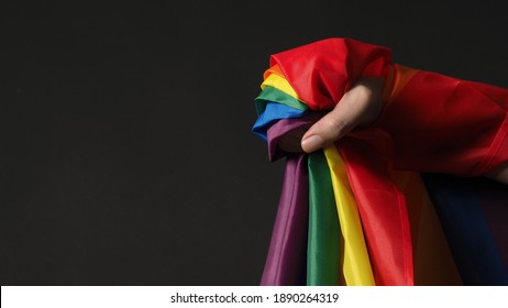 LGBTQ Flag Or Lesbian Gay Bi Sexsual Transgender Queer Or Homosexsual Pride Rainbow Flag On Black Background. Represent Hand Symbol Of Freedom, Peace, Equality And Love. LGBTQ Concept