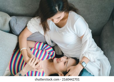 lgbtq, lgbt concept, homosexuality, portrait of two Asian women posing happy together and showing love for each other while being together - Shutterstock ID 2160442701