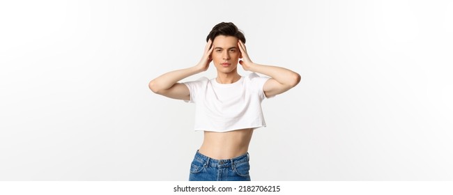 Lgbtq And Pride Concept. Beautiful And Confident Gay Man Wearing Crop Top, Touching Face And Looking Sassy At Camera, Standing Over White Background