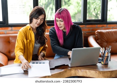 LGBTQ+ transgender man Beautiful Authentic Specialist with Pink Hair and Non-binary trans working together Working Design in creative workplace team work colleagues Gender equality. - Powered by Shutterstock