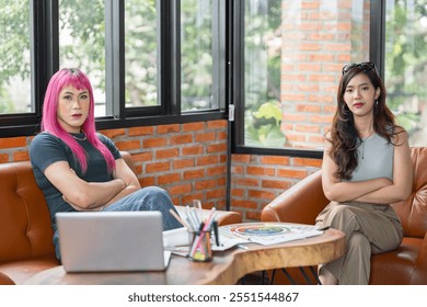 LGBTQ+ transgender man Beautiful Authentic Specialist with Pink Hair and Non-binary trans working together Working Design in creative workplace team work colleagues Gender equality. - Powered by Shutterstock