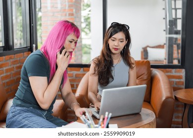 LGBTQ+ transgender man Beautiful Authentic Specialist with Pink Hair and Non-binary trans working together Working Design in creative workplace team work colleagues Gender equality. - Powered by Shutterstock