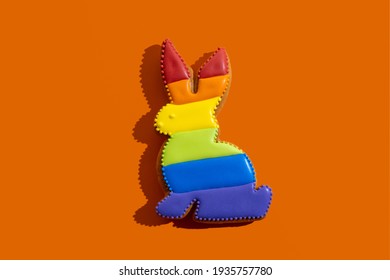 Lgbtqia Tolerance. Gay Pride Symbol. Bakery Food Decor. Conceptual Art. Bunny Gingerbread Cookie With Rainbow Flag Icing Ornament Isolated On Orange.