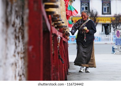 LHASA, CHINA - FEBRUARY 22: Unidentified Tibetan pilgrim circles the Potala palace during Tibetan New Year on February 22, 2012 in Lhasa, China. Devotees walk 3 times around the Potala for good luck.