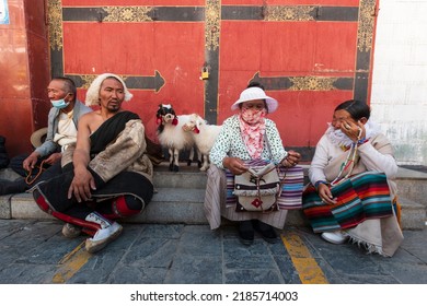 Lhasa, Tibet - August 3, 2022: Tibetan People Dressed In Traditional Attires In Barkhor Street