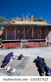 Lhasa. Tibet. China. 10.04.06. Buddhist pilgrims prostrate themselves before the Blue Buddha at the Palhalupuk Temple in Lhasa in the Tibet Autonomous region of China.