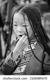 LHASA, TIBET, CHINA - AUGUST, 17 2018: Unidentified Tibetan child with typical clothing near the old Jokhang Temple in Lhasa, Tibet