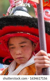 LHO, NEPAL - APRIL 20, 2014: Young traditional dressed up boy dances at a buddhist festival in the manaslu region on April 20, 2014 in Lho, Nepal.