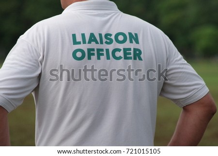 Liaison officer in charge and wearing a shirt showing clearly the function. Their strong organizational and communications skills make them critical to incident response.