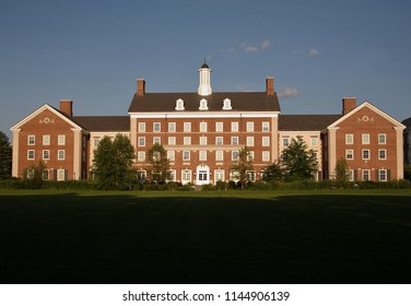 Liberal Arts College Building With A Shadowy Field In The Foreground