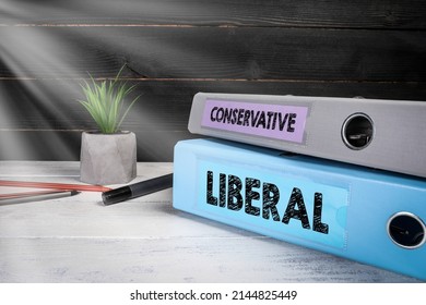 LIBERAL And CONSERVATIVE. Two Binders On Desk In The Office.