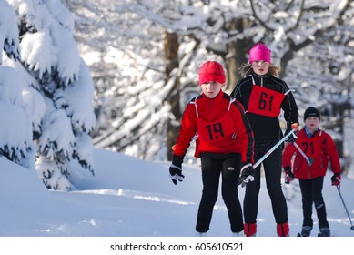 LIBEREC, CZECHIA - MARCH 16, 2017: Athlete In Kids Ski Cross-country Running Winter Competition In Snow Covered Landscape, , Group Of Three Uphill