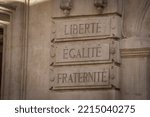 liberty, equality and fraternity written in French on a wall of a building