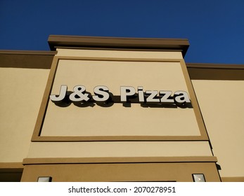 Liberty, Missouri USA - November 6 2021: Sign Above Building Entrance For J And S Pizza Beneath Blue Sky