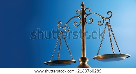 libra scale  against blue background            