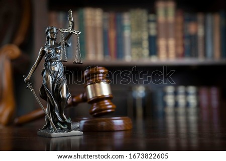 Library background. Judge's gavel on vintage lawyers desk. Legal office concept.