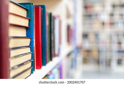 Library With Bookcases. Many Different Books On The Shelves. Large Selection Of Books In A Bookcase. Blur Background.