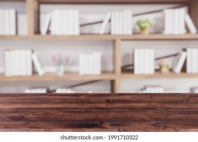 Library Bookshelf Blur Background With Blank Wooden Table Space For Products Montage Advertising Banner Backdrop.