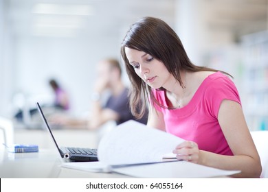 in the library - pretty female student with laptop and books working in a high school library  (color toned image) - Powered by Shutterstock