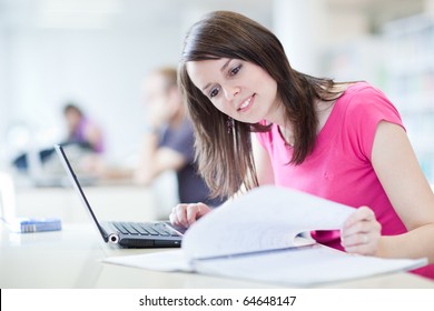 in the library - pretty female student with laptop and books working in a high school library  (color toned image) - Powered by Shutterstock